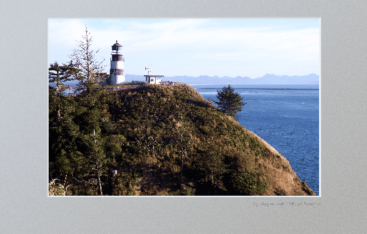 Cape Disappointment lighthouse on cliff overlooking Columbia River